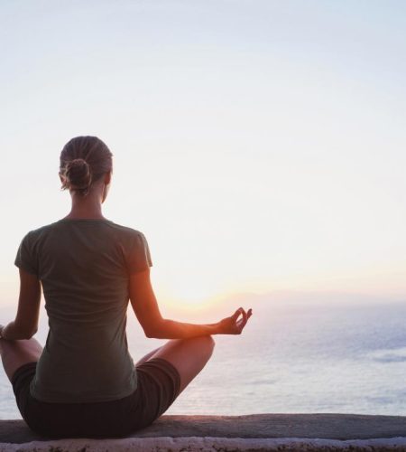 a-woman-meditating-by-the-sea